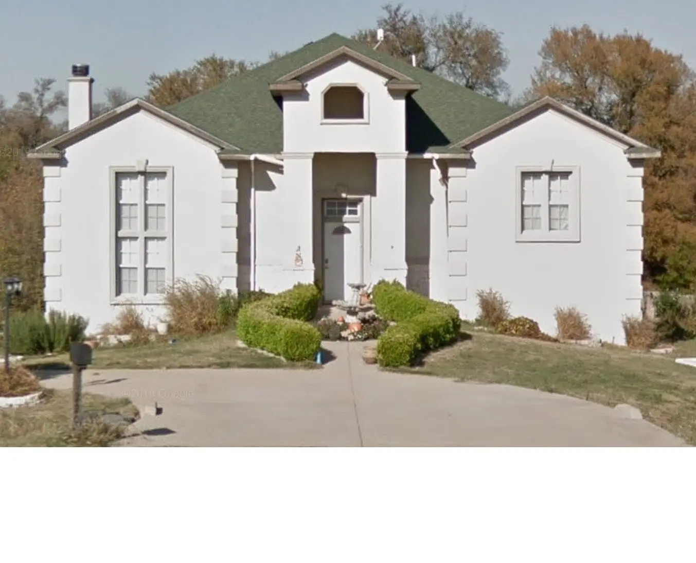 <p>Visualize a remodeled version of a classic suburban house exterior incorporating modern design aesthetics. The house should have a porch with contemporary railings, large energy-efficient windows, and a sleek front door. The surrounding landscape is minimalist, decorated with precisely trimmed topiary shrubs. Solar panels can be seen atop the house's gable roof. The home's facade is painted in a neutral color palette, skillfully blending various shades of whites and grays, covering an area of approximately 250 square feet.</p>