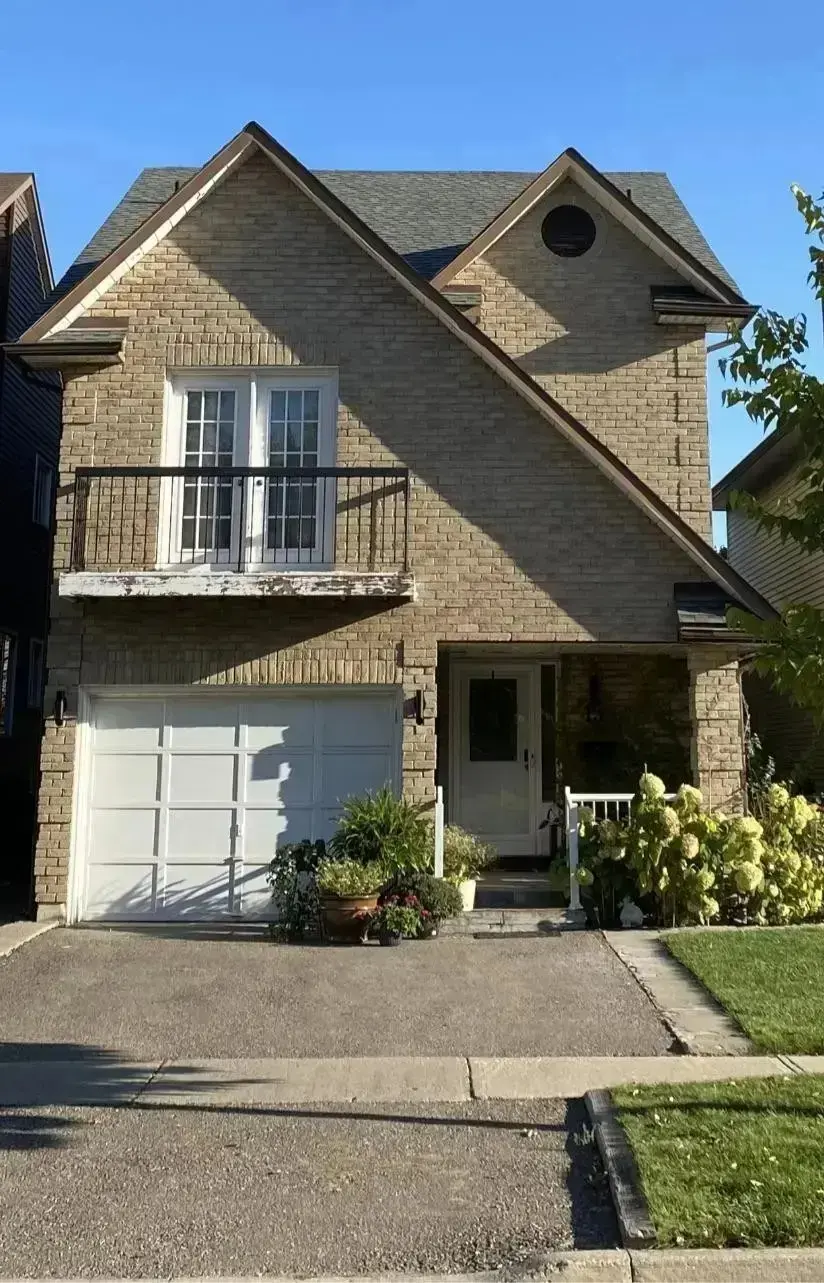 <p>Generate a highly realistic image of a modern, two-story house with a light-colored brick facade and enlarged windows. The balcony is adorned with sleek, modern railings, replacing older designs. The garage door is updated and features horizontal lines with a smooth finish. The landscaping is enhanced with an array of new plants and a tidy walkway, all embraced by a minimalist design approach. The rooftop is completed with neutral-colored shingles, and subtle lighting brilliantly emphasizing the entrance area to improve overall aesthetics. The front of the house measures approximately 25 feet in width and 20 feet in height.</p>