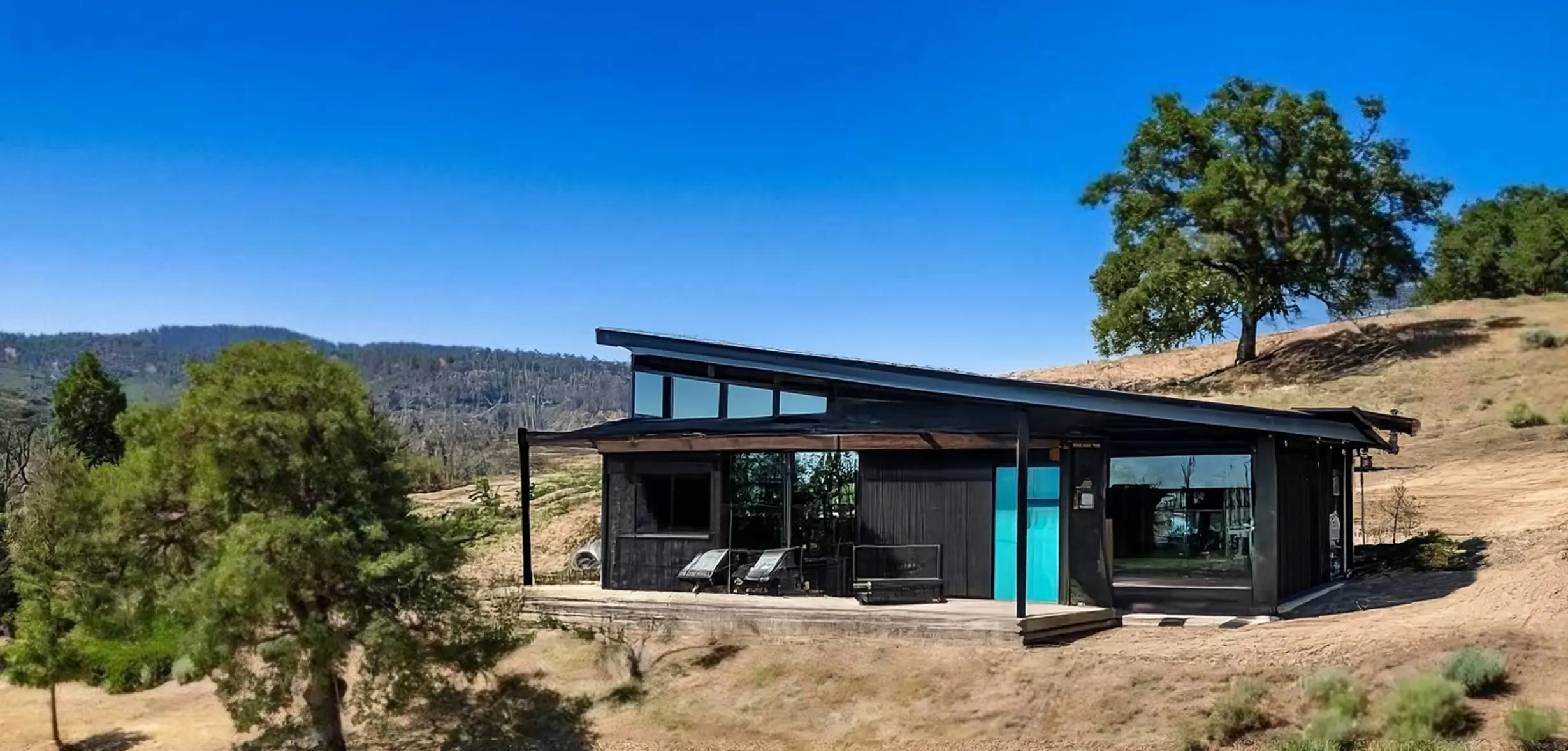 Industrial Style Exterior Remodel with Turquoise Door and Deck