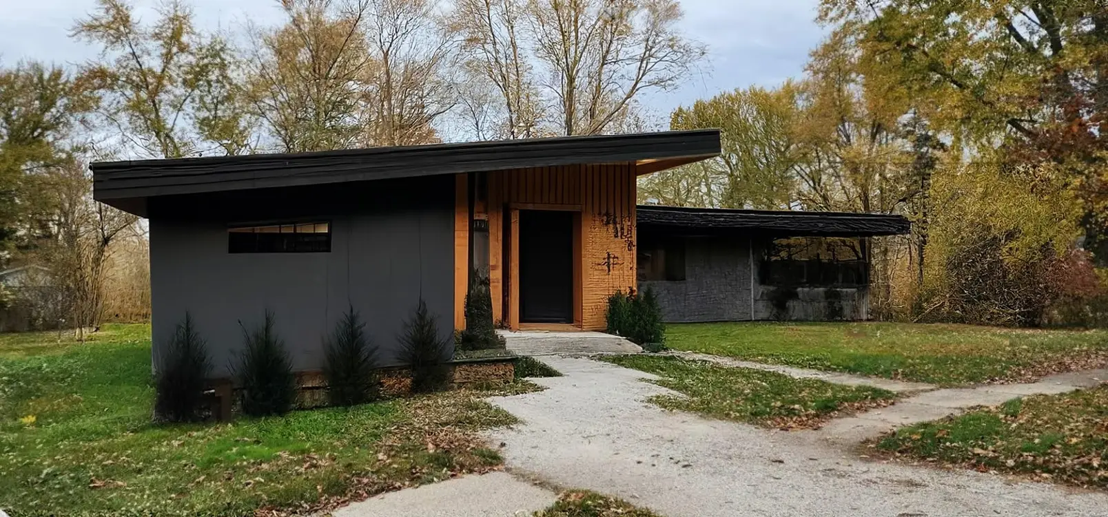 Modern Exterior Remodel with Cedar Porch and Dark Vinyl Siding