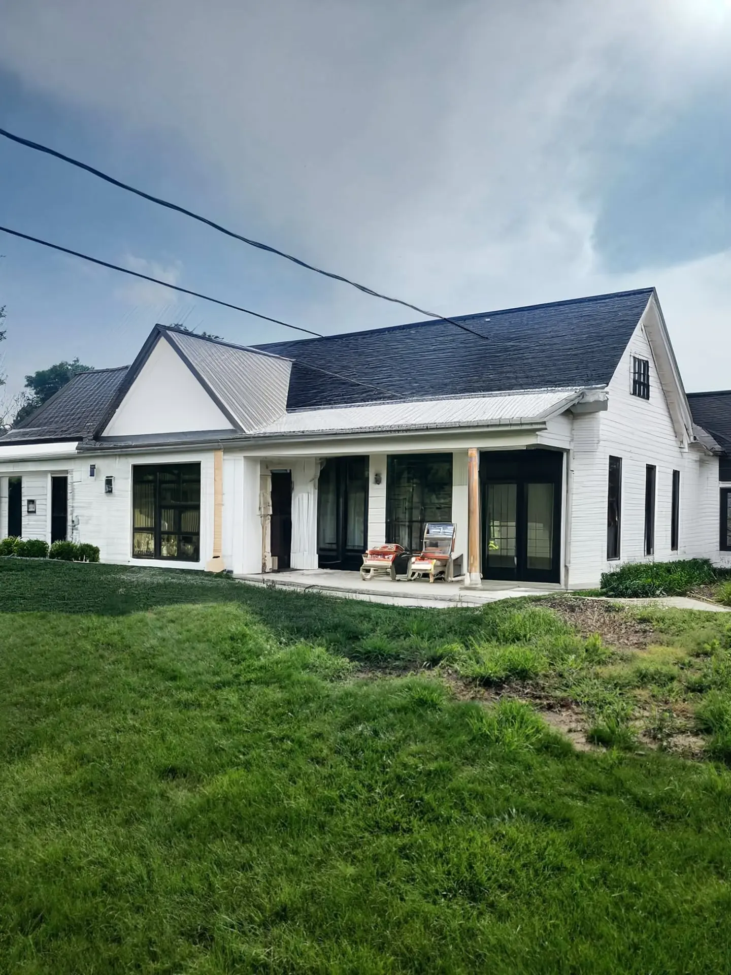 Charming Farmhouse Exterior Remodel with Rustic Porch and New Features