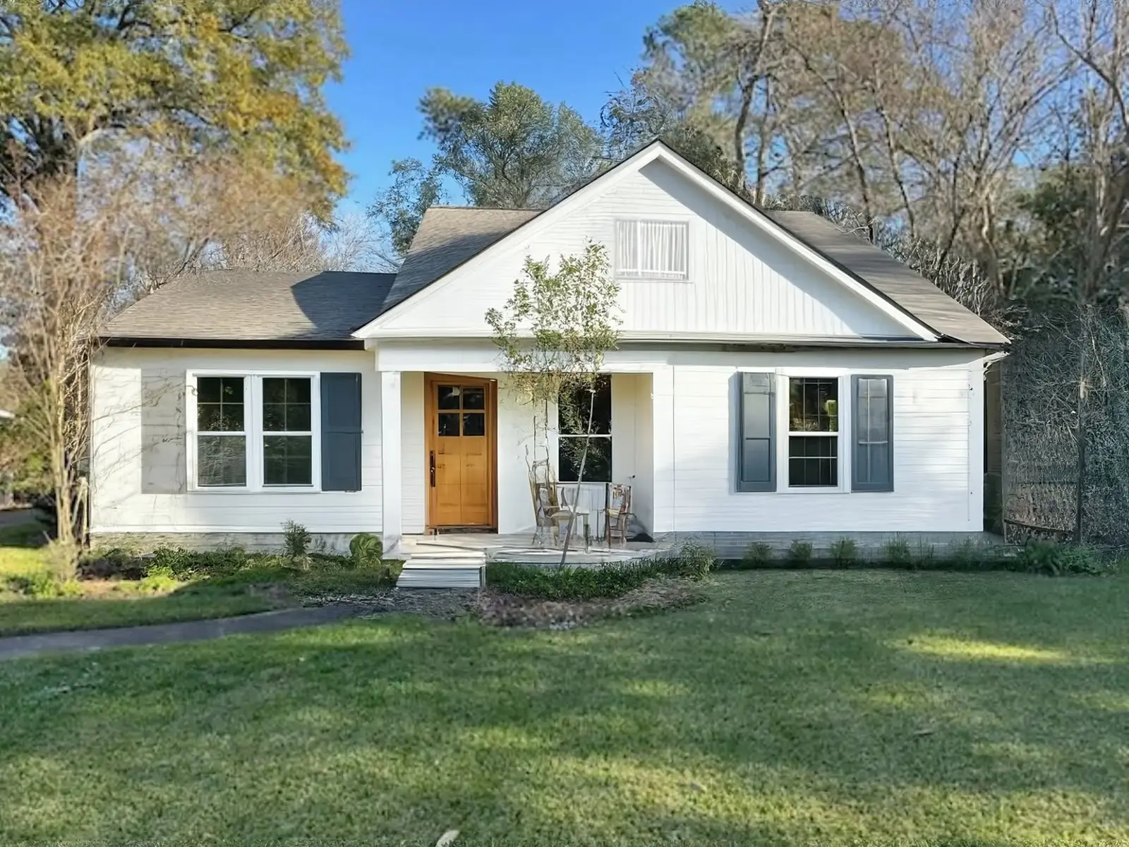 Traditional Home Exterior Remodel with Oak Door and Shutters